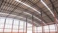 Steel wall framework structure with metal columns and curve roof beams in large industrial factory building in construction site Royalty Free Stock Photo