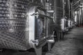 Steel wine tanks for wine fermentation at a winery. modern wine factory with large shine tanks for the fermentation Royalty Free Stock Photo