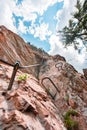 Steel Wire and Steps Going Up a Via Ferrata Climbing Path on a Steep Stone Cliff Wall Royalty Free Stock Photo