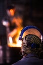 Steel worker in protective clothing raking furnace in an industrial foundry Royalty Free Stock Photo