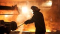 Steel worker removing slag from the electric induction crucible melting furnace at the metallurgical plant, hard work