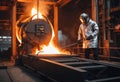 Steelmaker wearing protective clothe at ingot casting. Electric arc furnace shop. Metallurgy. steelmaker pours pig iron Royalty Free Stock Photo