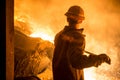 Steelworker when pouring liquid metal from tanks in the molds Royalty Free Stock Photo