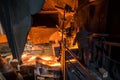 Steelworker at work near arc furnace and pouring liquid metal. Royalty Free Stock Photo