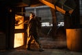 Steelworker at work near the working arc furnace Royalty Free Stock Photo