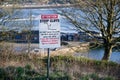 Steep cliffs warning sign for tourists high above Stonehaven harbour