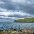 Steep coastline of Faroe Islands with sharp rocks