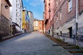 Steep cobblestone street with facades of old houses with lots of color on the sides