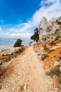 Steep dangerous mountain road with a big gravel in the mountains of Sardinia, Italy