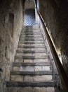 A steep flight of very old, stone steps between two stone walls leading to a studded wooden door. Royalty Free Stock Photo