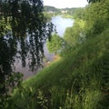 Steep green banks by a wide winding river.