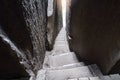 Steep narrow stairway between two gigantic rocks in rock garden Adersbach, Czech Republic