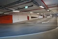 Steep paving descent to the parking lot. Brand new descending roads inside parking lot. Indoor parking lot exit passage