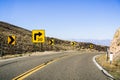 Steep right turn on a winding road; posted sign showing a 30 mph recommended speed; California Royalty Free Stock Photo