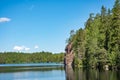 Steep rock at the lake shore on a clear sunny spring day Royalty Free Stock Photo