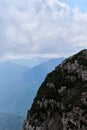 Nature and landscape of national Park in Caucasus. Cold summer day in mountains. Steep rocky mountain against background of snow Royalty Free Stock Photo