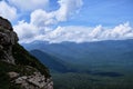 Nature and landscape of national Park in Caucasus. Cold summer day in mountains. Steep rocky mountain against background of snow Royalty Free Stock Photo