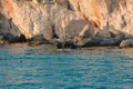 Steep rocky seashore, close-up view from the sea