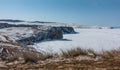 The steep shores of the frozen lake are covered with snow Royalty Free Stock Photo