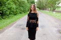 Steep slender Ukrainian woman on the asphalt old road