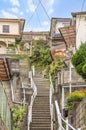 A steep slope with a narrow stair climbing between the Japanese houses piled up on the hillsides of Nagasaki.