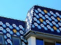 Steep sloped enamel coated clay tile Mansard roof. colorful flower pattern Royalty Free Stock Photo