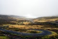 Steep and squiggly gravel road towards the fjords of Mjoifjordur in East Iceland Royalty Free Stock Photo