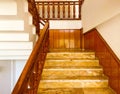 Steep stairs in the hotel. wooden handrails, marble steps for the descent of tourists into the hall. tile staircase, solid Royalty Free Stock Photo