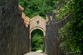 Steep stairs to a small church through green trees