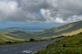 Steep and winding mountain road leading to the top of Connor Pass on the Dingle Peninsula