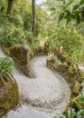 Steep winding path in the Quinta da Regaleira park in Sintra, Portugal. Like a stone snake between rocks and trees Royalty Free Stock Photo