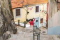 Steep winding street with railing down to Avenida de Gustavo Eiffel in Porto, Portugal