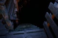 Steep wooden pier staircase leading down to sea level at night