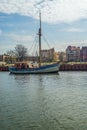 Old small wooden fishing boat sailing in harbor in the Old Town of Gdansk Royalty Free Stock Photo