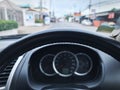 Steering Wheel Against Blurred Speedometer and Road Background Royalty Free Stock Photo