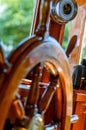 The steering wheel, binoculars and a barometer on a wooden boat Royalty Free Stock Photo