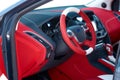 Steering wheel. Car dashboard. Car interior details. Red and black alcantara with stitching Royalty Free Stock Photo