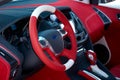 Steering wheel. Car dashboard. Car interior details. Red and black alcantara with stitching Royalty Free Stock Photo