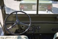 Steering wheel and controls of an old green Jeep Willys military SUV