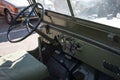 Steering wheel and controls of an old green Jeep Willys military SUV