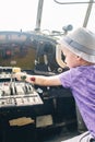 A close up of the cockpit of a vintage airplane. The steering wheel, dashboard, seat and climb levers are visible. Decommissioned