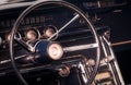 Steering wheel, dials and knobs on dashboard and front panel of an old timer car Royalty Free Stock Photo