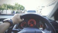 Steering wheel with driver hand on it in car with view of street and another car nearly, Transportation, Businessman driving Royalty Free Stock Photo