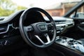 Steering wheel equipped with standard driver's-side airbag on Audi model. Key interface serving as control panel for