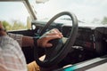 Steering wheel hands press car horn in road trip, traffic jam and journey. Closeup travel man, taxi driver and motor Royalty Free Stock Photo