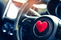 Steering wheel with heart red object.Love car concept idea.interior console car. Royalty Free Stock Photo