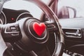 Steering wheel with heart red object.Love car concept idea.interior console car Royalty Free Stock Photo