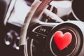 Steering wheel with heart red object.Love car concept idea.interior console car Royalty Free Stock Photo