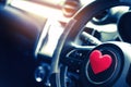 Steering wheel with heart red object.Love car concept idea.interior console car. Royalty Free Stock Photo