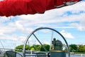 Steering wheel and red sails of tall ship against sky. Royalty Free Stock Photo